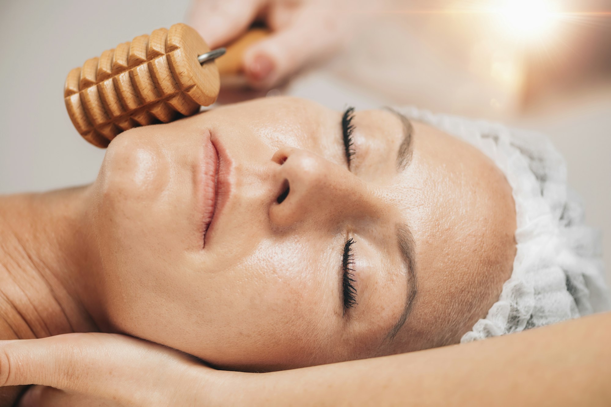 Maderotherapy Face Massage with Wooden Roller. Reducing Wrinkles and Sagging Cheeks