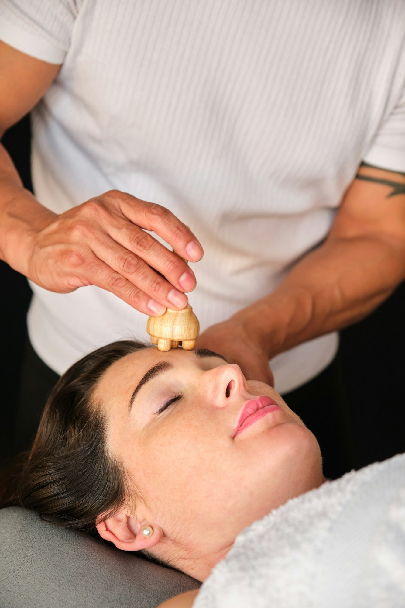 Woman getting face maderotherapy in a beauty salon.
